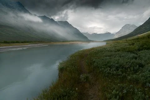 Heavy clouds rolling above remote arctic valley. Rapadalen, Sarek National Park Stock Photos
