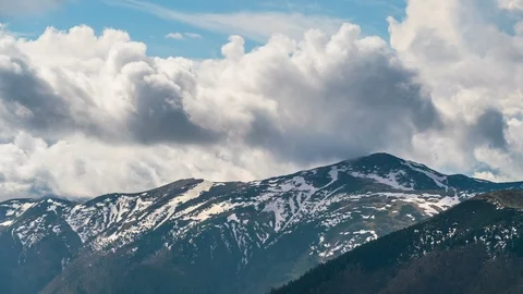 Heavy clouds sky motion over alpine mountains in early spring Nature Time lapse Stock Footage 108776094