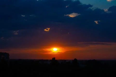 Heavy cloudy sky at sunset. A landscape of beautiful nature Stock Photos
