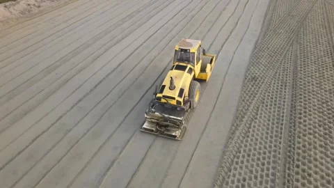 Heavy compactor roller compacting the sand for road foundation Stock Footage 293012027