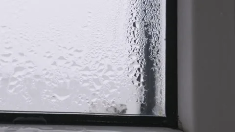 Heavy Condensation with Water Droplets on Window Glass Stock Footage 325338053