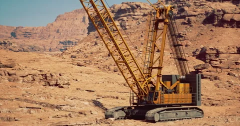 Heavy construction crane operates in arid desert landscape for mining projects Stock Footage 321430788