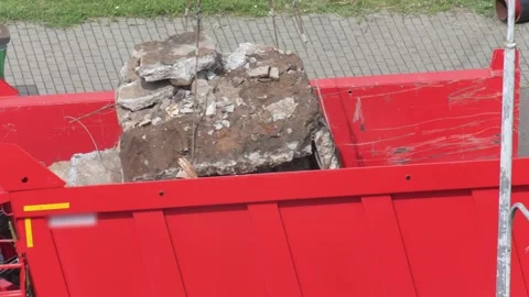 Heavy construction debris with broken concrete, dirt, and rebar being loaded Stock Footage 344864060