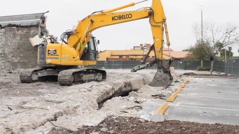 Heavy construction equipment almost tips and falls over trying to grab huge  Stock Footage 125056527