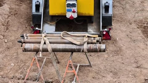 Heavy Construction Equipment with Pipe Support at a Job Site for Various Tasks Stock Photos