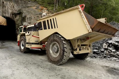 Heavy construction machinery with large dump bed positioned near tunnel ent.. Photos