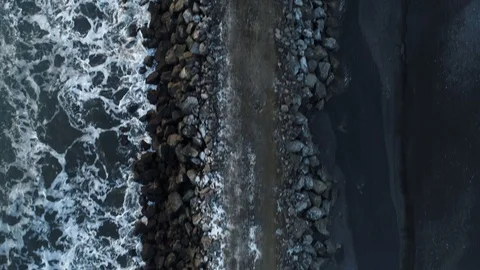 Heavy construction vehicles moving rocks on the coast in Vik, Iceland Stock Footage 122308727