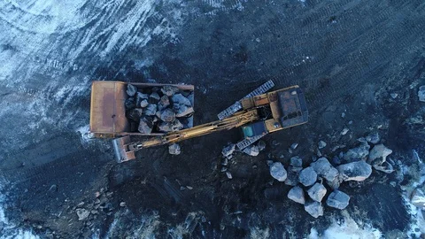 Heavy construction vehicles moving rocks on the coast in Vik, Iceland Stock Footage 122374554