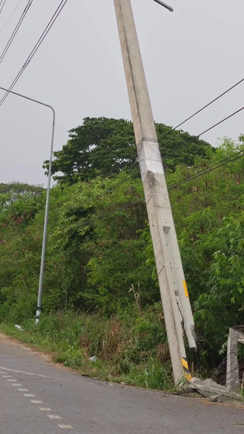 Heavy crane lowering a severely broken concrete power pole damaged. Stock Footage 338194827