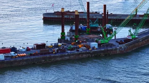 Heavy cranes developing coastal infrastructure drone shot Video stock 333427459