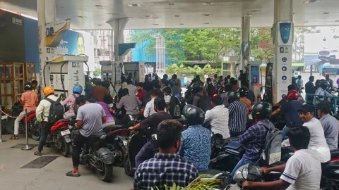 Heavy crowded people with motorcycles lined up in Bharat Petroleum petrol bunk Stock Footage 334794043