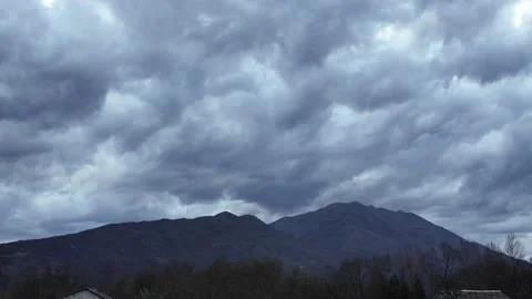 Heavy dark blue rain clouds above mountains. Stock Footage 317630994