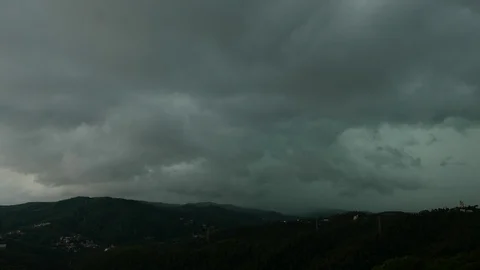 Heavy dark clouds over green mountains, before storm Stock Footage 99514754