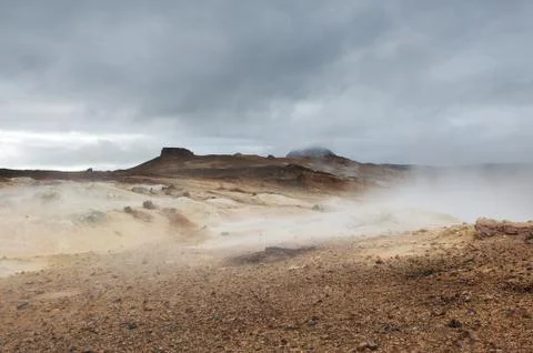Heavy dark clouds over Hverir area covered with steam, Iceland Stock Photos