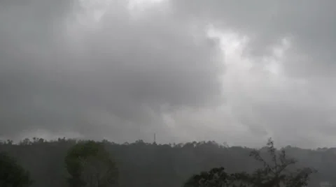 Heavy dark cloudy moving, rains in an open hilly, environment Stock Footage 38031653