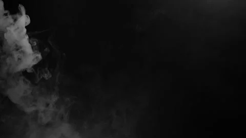 A heavy, dense cloud of white fog churns slowly on the left side of a black Stock Footage 320245739