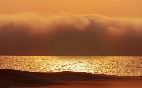 Heavy dramatic clouds and bright sky over the Atlantic Ocean. Beautiful afric Stock Photos