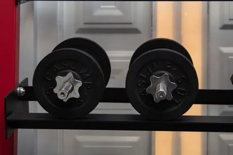 Heavy dumbbell for physical training in gym Stock Photos