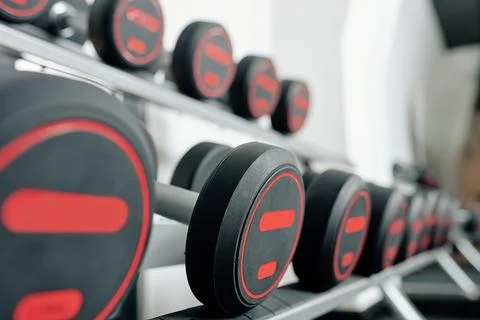 Heavy dumbbells on rack Stock Photos