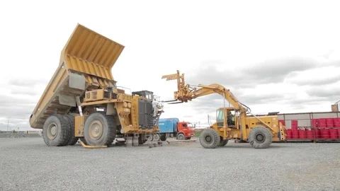 Heavy dump truck and loader in open pit Stock Footage 83504355