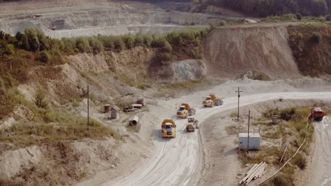 Heavy Dump Trucks At The Coal Mining Area. Aerial view of the quarry mining Stock Footage 194749496