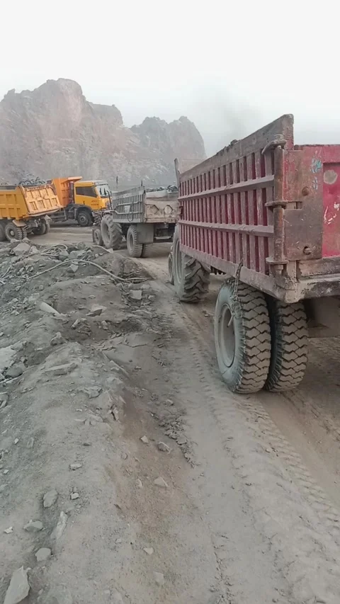 Heavy Dump Trucks Operating in a Mountainous Mining Quarry (2) Stock Footage 337727724