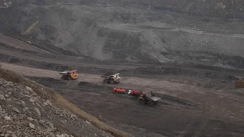 Heavy dump trucks ride along the coal open pit Stock Footage 83504296