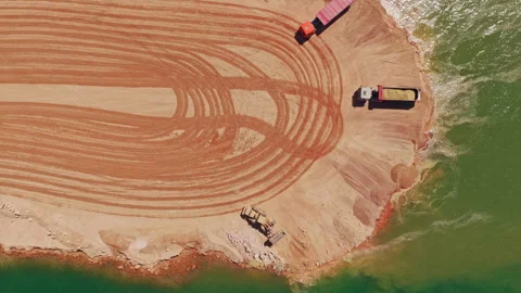 Heavy dump trucks working on riverbank construction site Stock-Footage 345007405