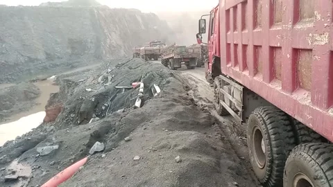 Heavy dumper trucks lined up on dirt road at industrial quarry mining site f Video stock 341243026