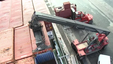 Heavy duty container handler moving shipping containers in harbor slow motion Stock Footage 102629625