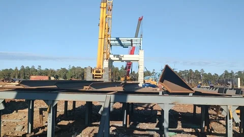 Heavy-Duty Crane Operations at Massive Bridge Construction Site Stock Footage 337244670