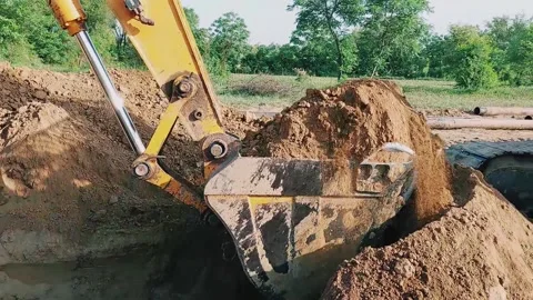 Heavy Duty Excavator Digging Deep Trench For Industrial Pipeline Installation Stock Footage 333494281