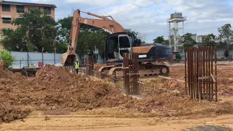 Heavy Duty Excavator Digging Soil at Construction Site Groundworks Stock Footage 333853949