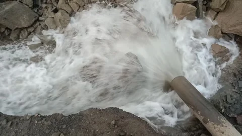 Heavy-Duty Pumping System Discharging Water at a Mining Site Stock Footage 338298212