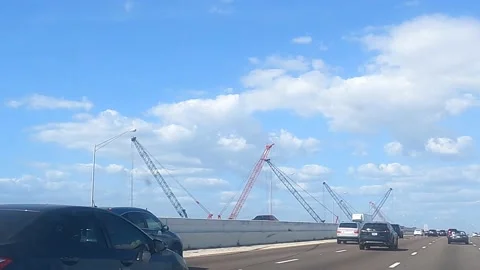 Heavy equipment Construction cranes on the side of highway Stock Footage 156133566