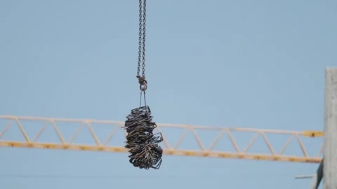 Heavy equipment lifts a load at a construction site in the city Stock Footage 338245552