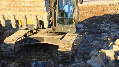 Heavy equipment operator drives a crawler excavator Stock Footage 70733100