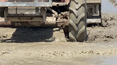 Heavy equipment passes through flooded farmland blending soil and water for crop Stock Footage 330174518