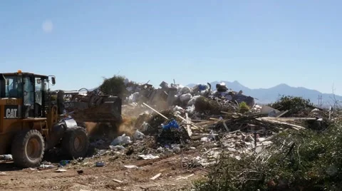 Heavy equipment pushing trash at a landfill Stock Footage 59672172