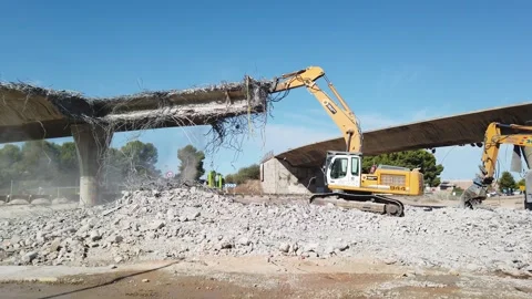 Heavy Equipment taking down a Bridge to build a New Park Stock Footage 249177632