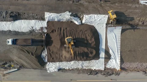 Heavy equipment work at a road construction site. Aerial top-down view. Stock Footage 158973174