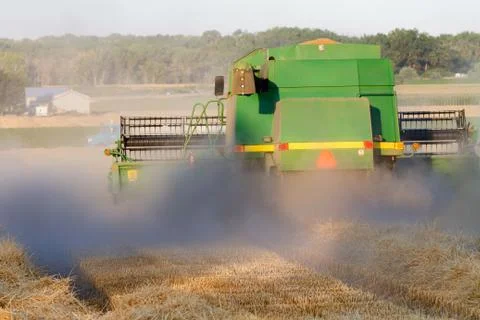 Heavy equipment working the fields during harvest time in at the end of summer Stock Photos