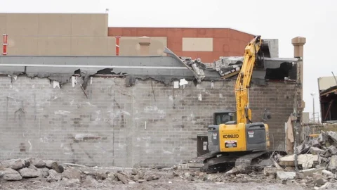 Heavy excavator construction machine destroys wall at demolition site B Stock Footage 125056835