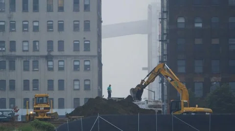 Heavy excavator picking up mud at construction site Stock Footage 61132710