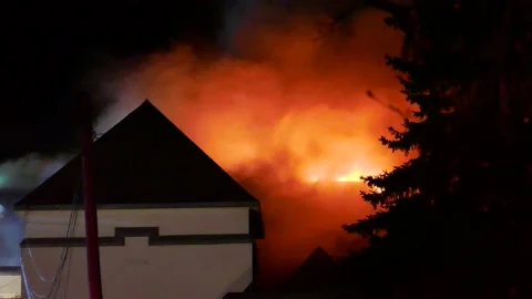 Heavy flames at huge structure fire Stock Footage 139657150