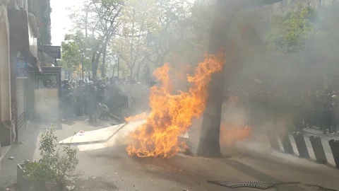 Heavy flames on the sidewalk during demonstration Stock Footage 107859460