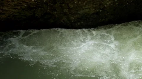 Heavy flow of water on the edge of the river Видео 297634213