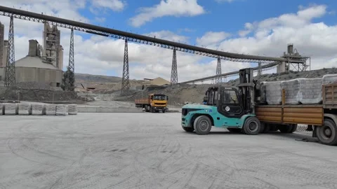 Heavy Forklift Operating in Large Cement Factory with Industrial Infrastructure Stock Footage 331360764