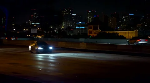Heavy freeway traffic at night with downtown San Diego in background Stock Footage 42565145