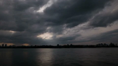 Heavy gloomy clouds over river.4K (4986x2304)   Time lapse without birds, RAW  Stockbeeldmateriaal 48476269